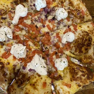 a hand holding a pizza