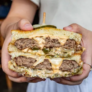  a person holding a sandwich
