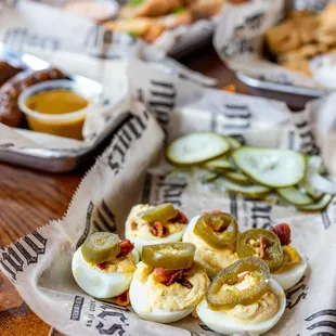 a tray of deviled eggs and pickles