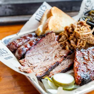 a tray of meat and sides