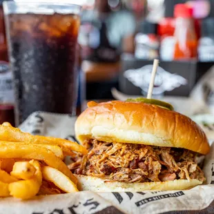 a pulled pork sandwich and fries