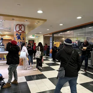 a crowd of people in a mall