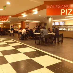 people sitting at tables in a restaurant
