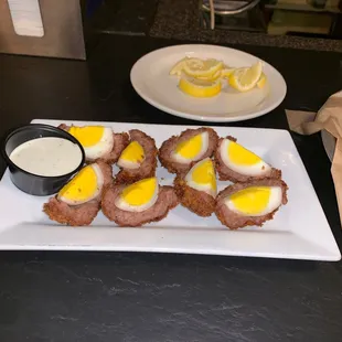 Scotch egg served with ranch dressing.