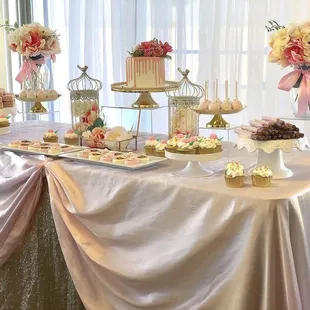a table with a cake and cupcakes