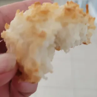 a hand holding a half eaten pastry