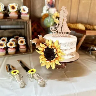 a wedding cake and sunflowers