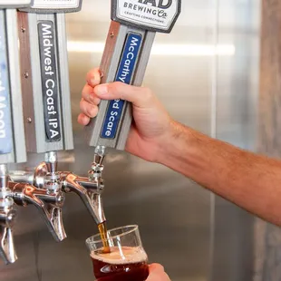 a person pouring a beer