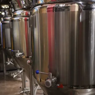 a row of stainless steel tanks