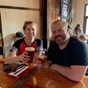 A couple enjoying a beer in MAD Brewing