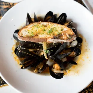 a plate of mussels and bread