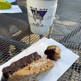 a half eaten pastry and a cup of coffee