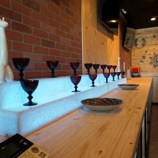 a row of wine glasses on a bar
