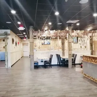 a restaurant with a bar and chairs