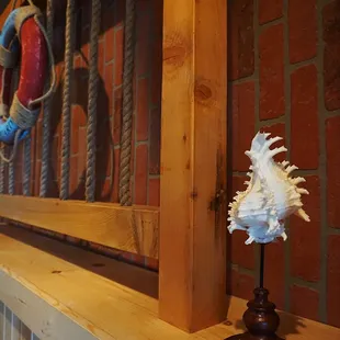 a red brick wall and a white sea shell