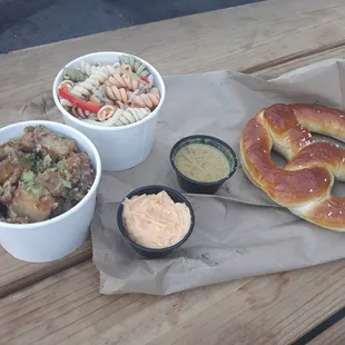 Pasta and potato salad and pretzel.