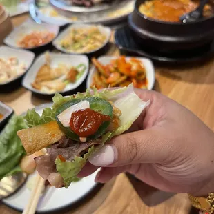 a person holding a piece of food