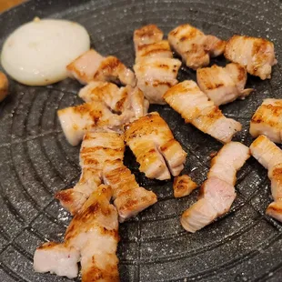 a plate of meat on a grill