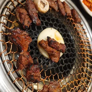 the meat being cooked on the grill