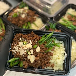 a person holding a tray of food