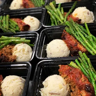 a tray of meatballs and asparagus