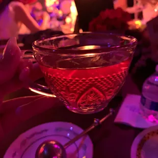 a glass of tea with a spoon in it
