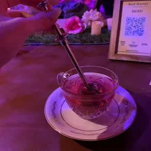 a person holding a spoon in a bowl of ice cream