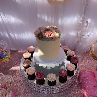a cake and cupcakes on a table