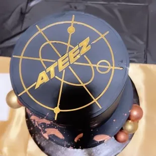 a black and gold cake on a table