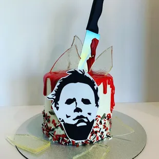 a knife and bloody face on a cake