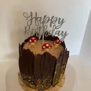 a cake with a happy birthday sign