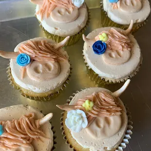 a number of decorated cupcakes