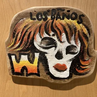 a painted rock with a woman&apos;s face