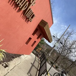 a motorcycle parked in front of a red building