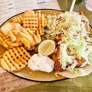 a plate of food with waffles, coleslaws, and coleslaw