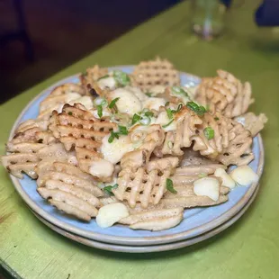 Waffle fry poutine - crispy waffle fries topped with our Gobblerito gravy, cheddar cheese curds &amp; scallions