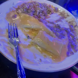 Enchilada plate with cheese, enchilada, queso, rice, and beans. next time we would get con carna sauce for better balance.