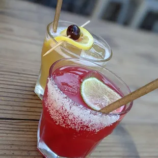 two cocktails on a wooden table