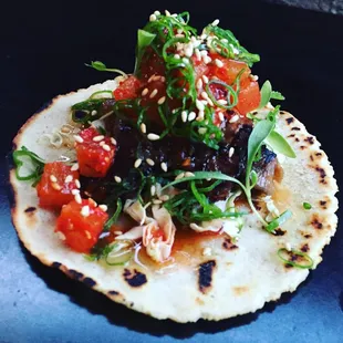 Ton Ton Tattoo- House made corn tortilla, sliced brisket, napa cabbage, kimchi daikon, korean chili vinaigrette, scallion, sesame