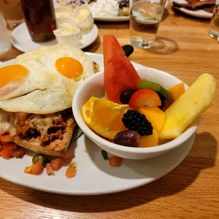 Mexico City Breakfast - steak bun topped with refried beans, Monterrey cheese and real homemade pico de gallo, served with two eggs + a side