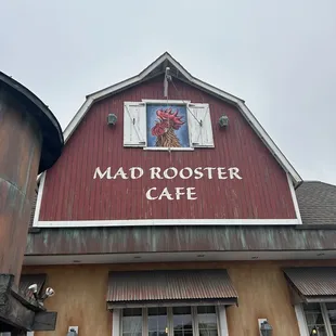 a red barn with a sign that says mad rooster cafe