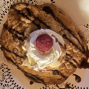 Chocolate Chip Cookie topped with Vanilla Ice Cream and a Raspberry. very tasty but the cookie was very hard.