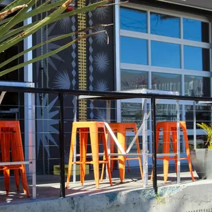 a row of orange chairs outside a restaurant
