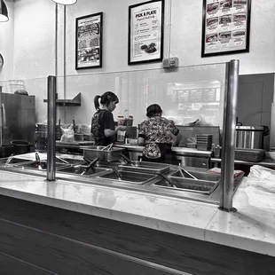 a black and white photo of a restaurant kitchen