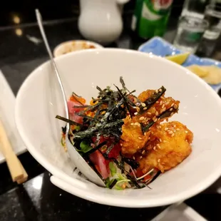 a bowl of food with chopsticks