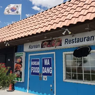 a korean restaurant with a red roof