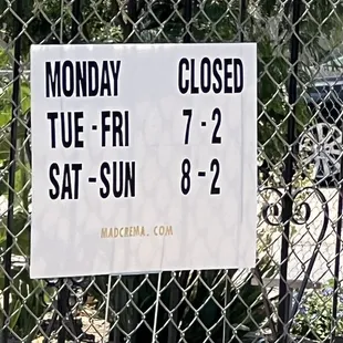 a closed sign on a chain link fence