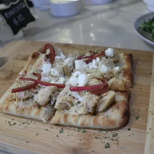a wooden cutting board with a pizza on it