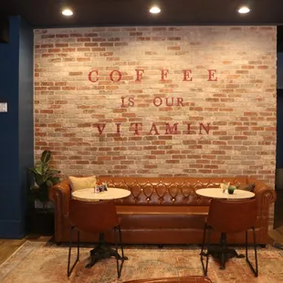 a coffee shop with a brick wall