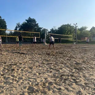 a group of people playing volleyball